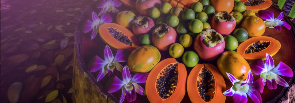 whole fresh fruits arranged in a circular array in a natural tropical setting. The fruits include persimmon, lime, orange, and mango, with sliced papayas showing their seeds interspersed throughout.