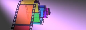 A fragment of movie film, each frame a different rainbow color