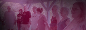 Body Electric Community members holding hands in a circle